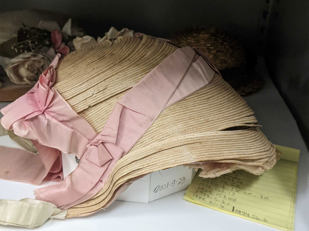 Natural straw bonnet with a pink ribbon from JCHS's collection
